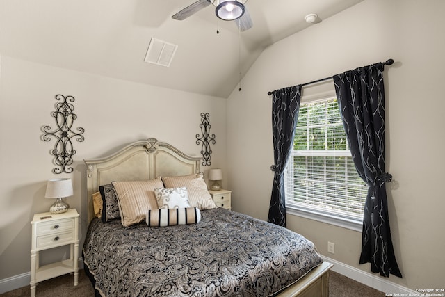 carpeted bedroom with ceiling fan and lofted ceiling