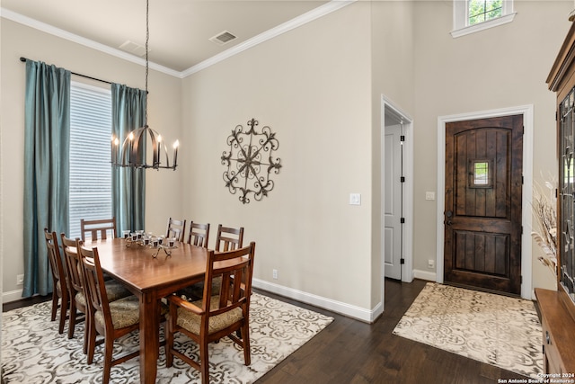 dining room featuring an inviting chandelier, crown molding, and dark hardwood / wood-style flooring