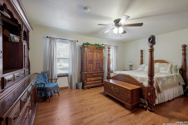 bedroom with light hardwood / wood-style floors and ceiling fan