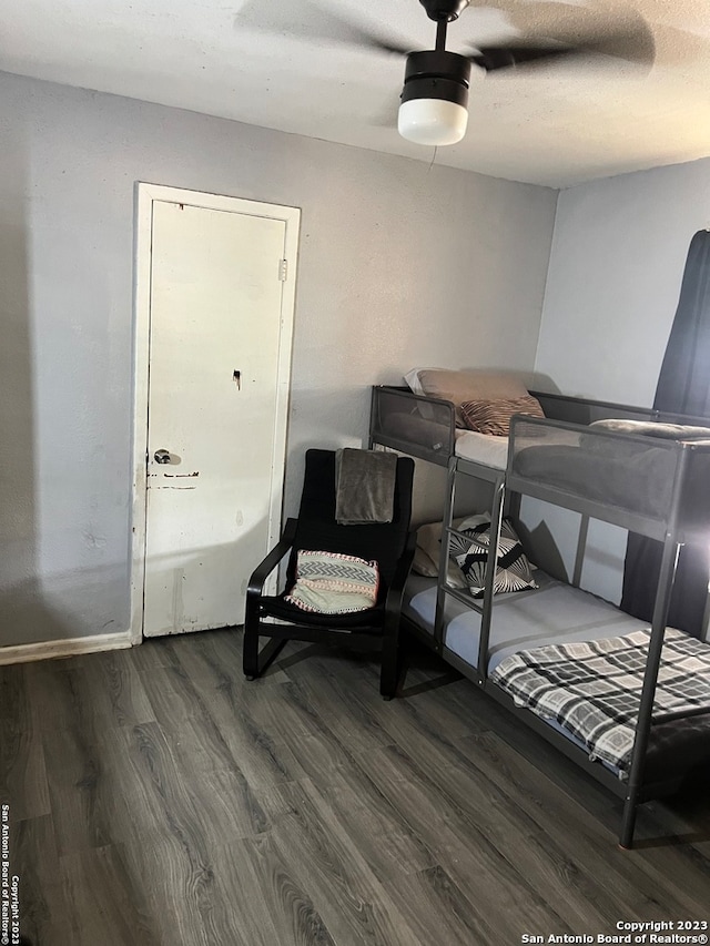 bedroom featuring ceiling fan and dark wood-type flooring