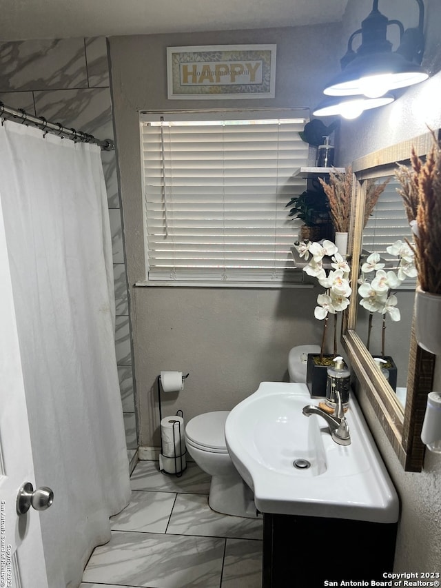 bathroom featuring tile floors, toilet, and vanity