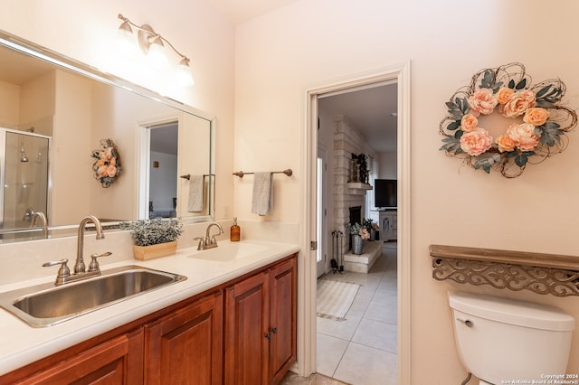 bathroom with toilet, tile flooring, and dual vanity