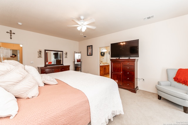 carpeted bedroom with ceiling fan and ensuite bathroom