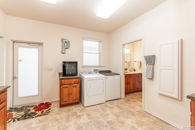 washroom featuring cabinets, separate washer and dryer, light tile floors, and hookup for a washing machine