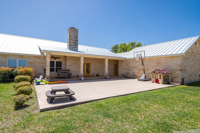 back of house with a patio and a yard