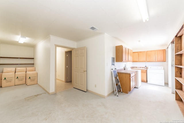 kitchen featuring crown molding and washer / dryer