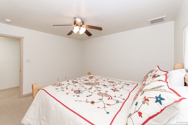 bedroom featuring ceiling fan and light carpet