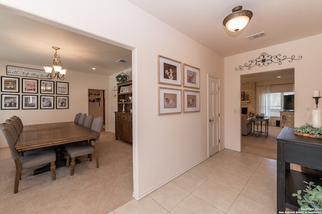 dining room with a notable chandelier and light tile floors