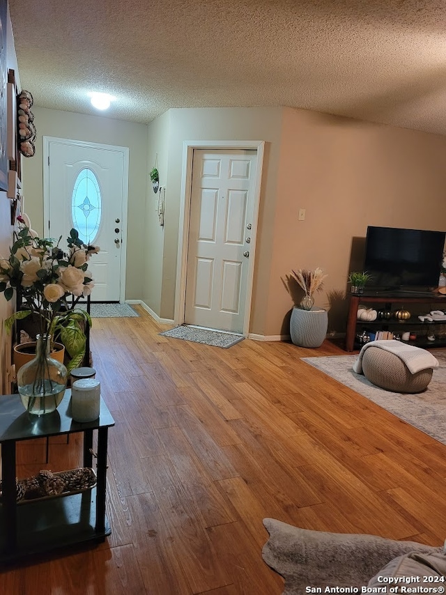 foyer entrance featuring a textured ceiling and hardwood / wood-style floors