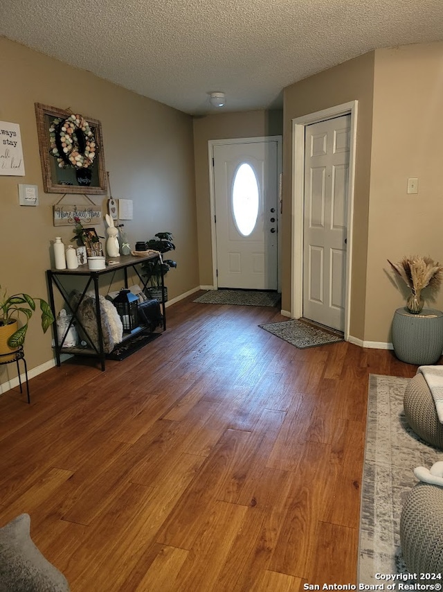 foyer with hardwood / wood-style flooring and a textured ceiling