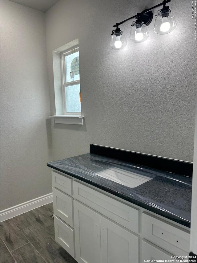 bathroom with vanity and hardwood / wood-style flooring