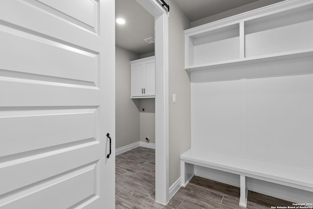 mudroom with wood-type flooring and a barn door