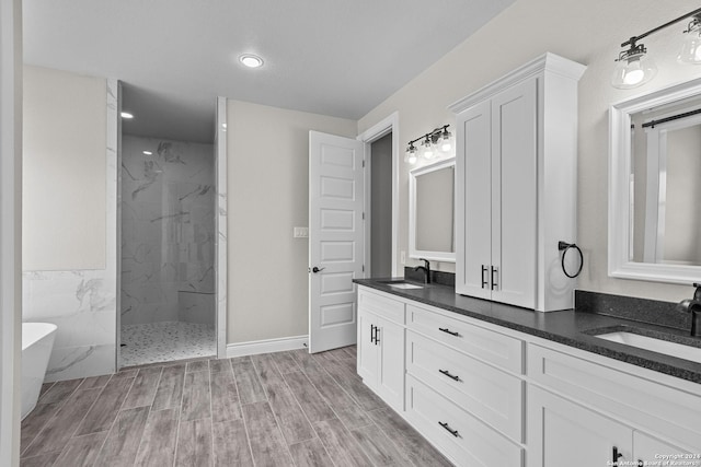 bathroom with hardwood / wood-style floors, vanity, tile walls, and independent shower and bath