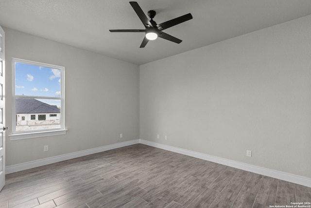 spare room with light hardwood / wood-style flooring and ceiling fan