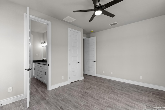 unfurnished bedroom with connected bathroom and ceiling fan