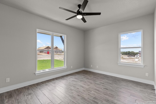 empty room featuring ceiling fan and light hardwood / wood-style flooring