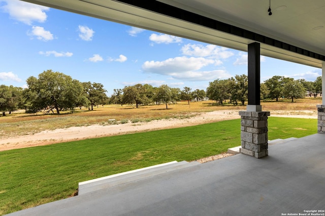 view of yard featuring a rural view and a patio area