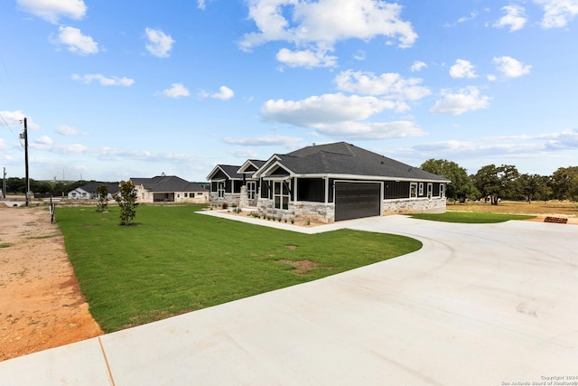 rear view of property with a lawn, a sunroom, and a garage