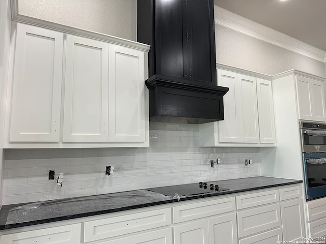 kitchen featuring white cabinets, crown molding, and black cooktop