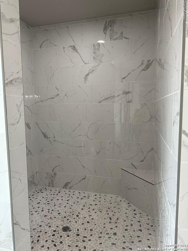 bathroom with a tile shower