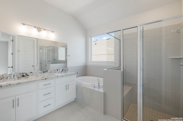 bathroom with vanity, independent shower and bath, lofted ceiling, and tile patterned flooring