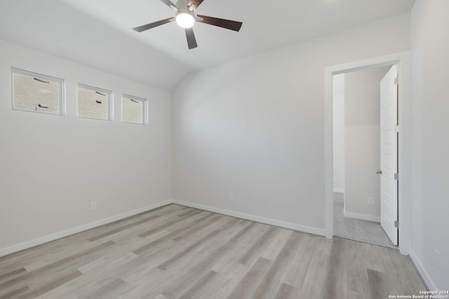 unfurnished room with vaulted ceiling, light hardwood / wood-style flooring, and ceiling fan