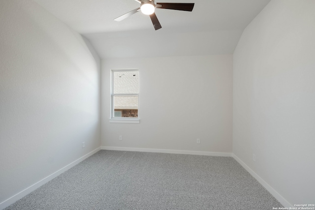 carpeted spare room featuring ceiling fan and lofted ceiling