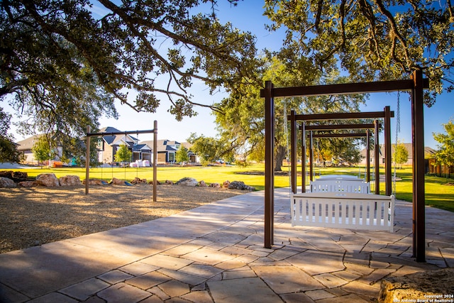 view of property's community featuring a lawn and a playground