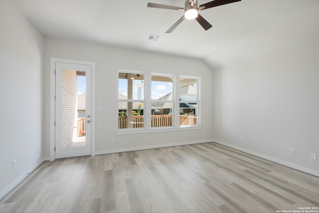 empty room featuring lofted ceiling, light hardwood / wood-style flooring, and ceiling fan