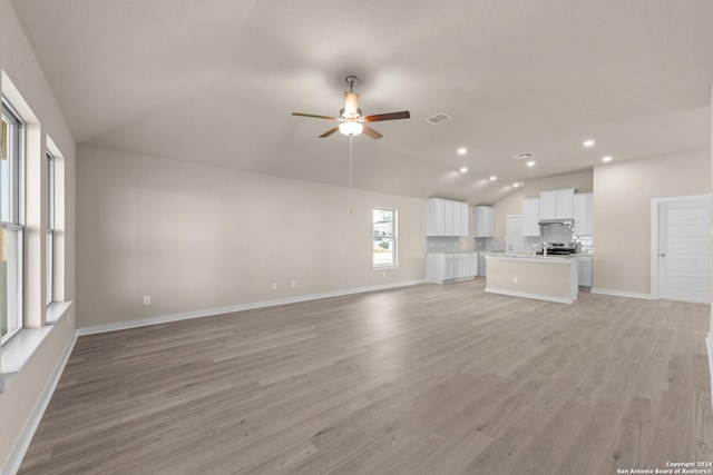 unfurnished living room with ceiling fan, light hardwood / wood-style flooring, and lofted ceiling