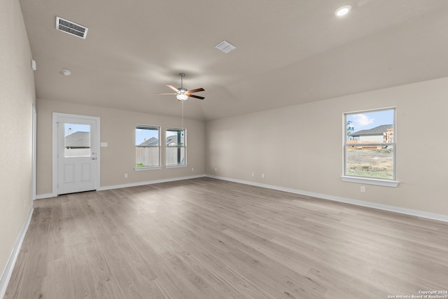 unfurnished living room featuring ceiling fan, vaulted ceiling, and light wood-type flooring