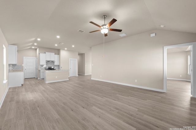 unfurnished living room with ceiling fan, light hardwood / wood-style floors, and lofted ceiling