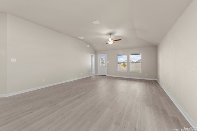 unfurnished room featuring ceiling fan, lofted ceiling, and light wood-type flooring