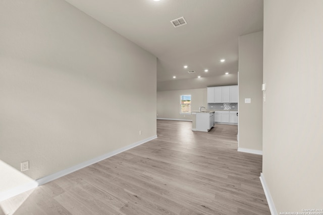 unfurnished living room with light wood-type flooring