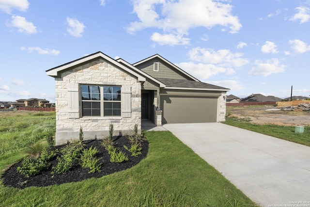 view of front of property featuring a garage and a front lawn