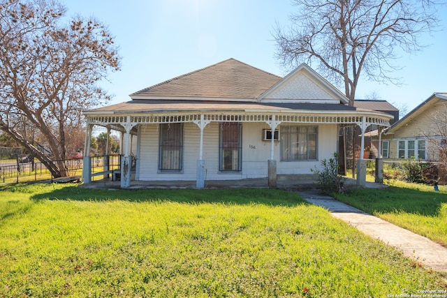 view of front of home with a porch and a front lawn