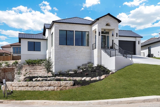 8214 Sierra Hermosa, San Antonio, TX 78255 - contemporary house with a standing seam roof, metal roof, a garage, driveway, and stone siding