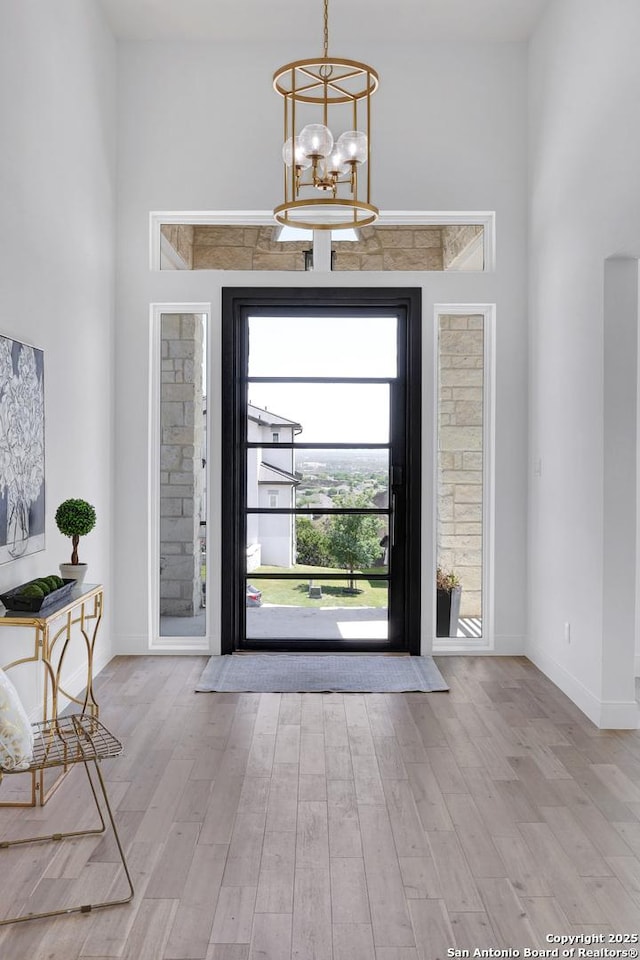 8214 Sierra Hermosa, San Antonio, TX 78255 - entryway with wood finished floors, a chandelier, and baseboards