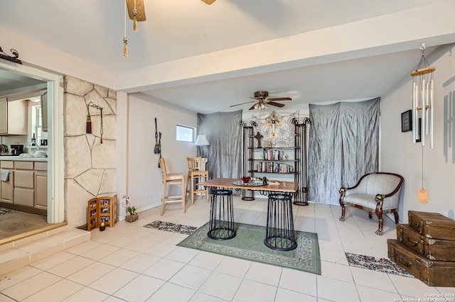 tiled dining space featuring ceiling fan