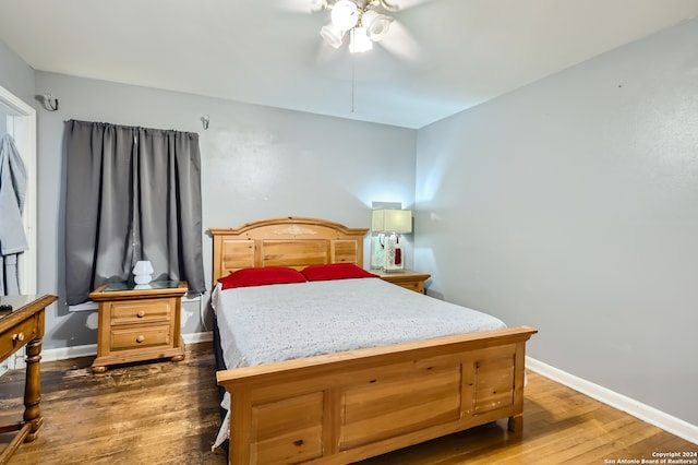 bedroom with dark hardwood / wood-style floors and ceiling fan