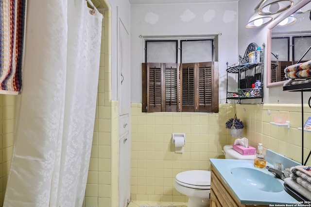 bathroom featuring tile walls, tile floors, toilet, and large vanity