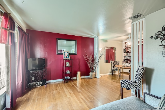 sitting room featuring ceiling fan and light wood-type flooring