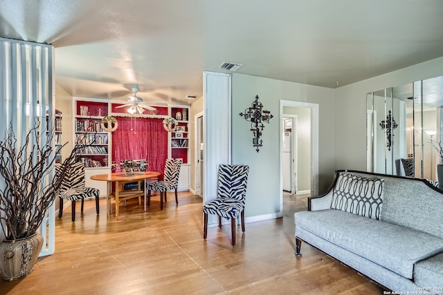 sitting room featuring ceiling fan and light hardwood / wood-style flooring