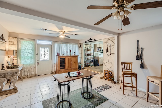 interior space with ceiling fan and light tile floors