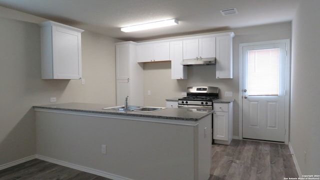 kitchen with white cabinets, sink, dark wood-type flooring, and stainless steel range with gas cooktop