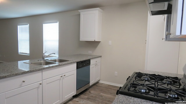 kitchen with white cabinets, light hardwood / wood-style flooring, sink, light stone counters, and dishwasher