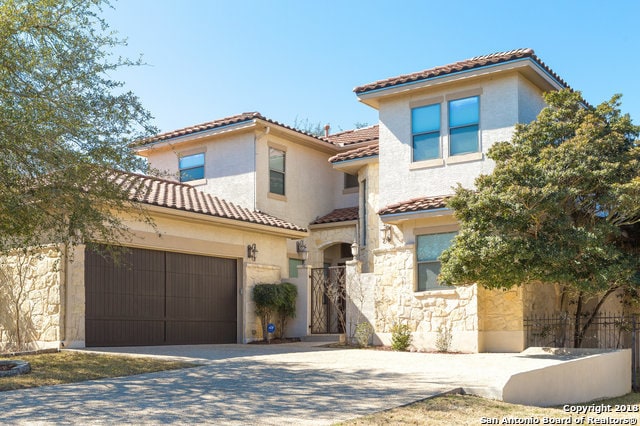 mediterranean / spanish-style house with a garage