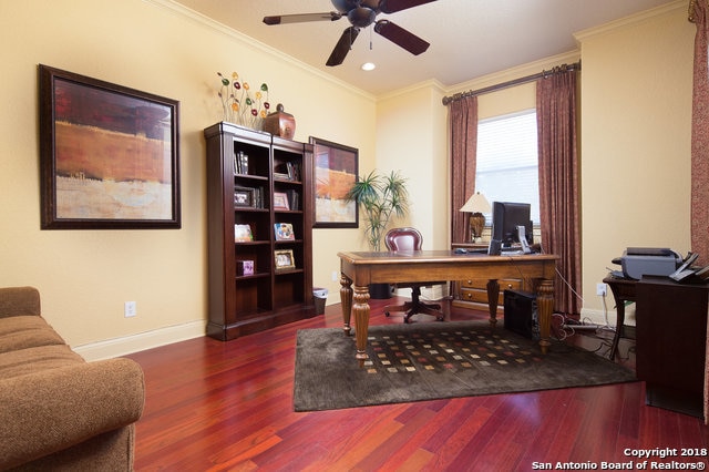 office space featuring ceiling fan, ornamental molding, and dark hardwood / wood-style floors