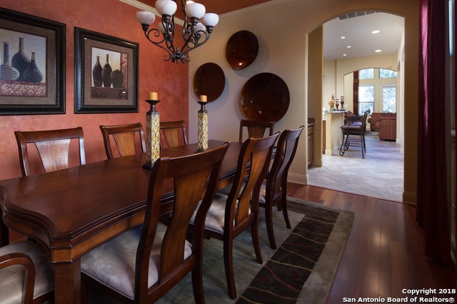 dining space with a notable chandelier and dark wood-type flooring