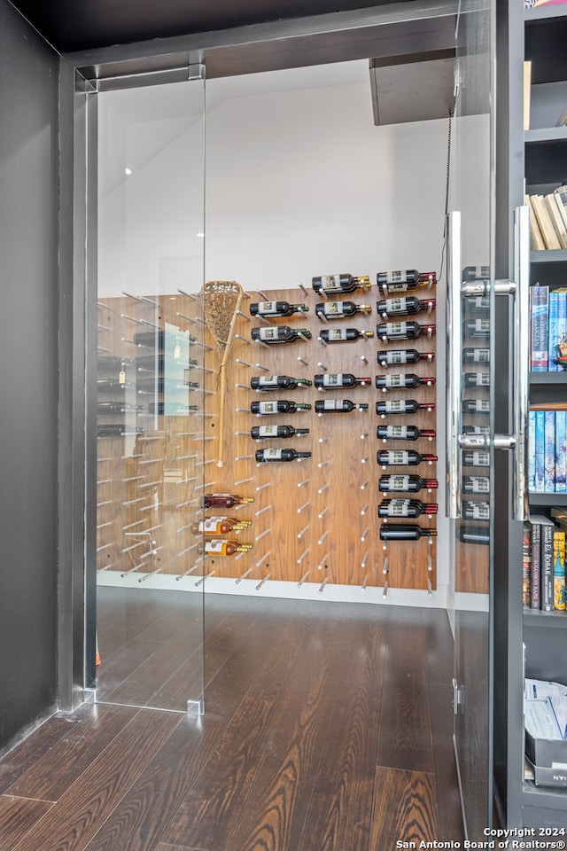 wine area featuring lofted ceiling and wood-type flooring